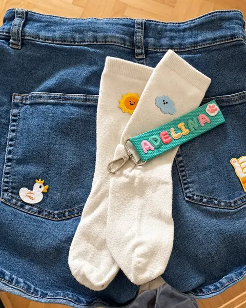 Duck, sun, cloud and thumbs-up patches on a denim skirt and socks